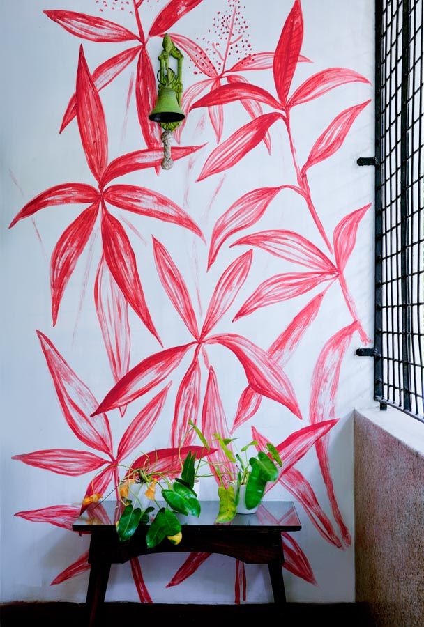 A red artwork painted on a white wall in a balcony - Beautiful Homes