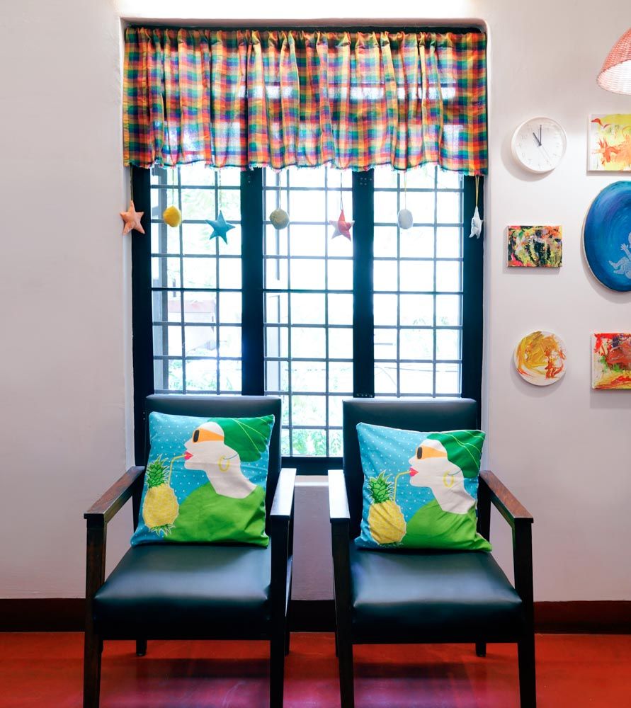 A room with a couple of chairs sitting in front of a black framed window - Beautiful Homes