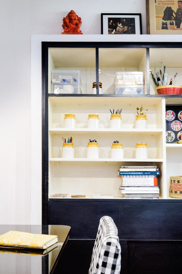 A black framed storage area with pickle jars used as pencil stands - Beautiful Homes