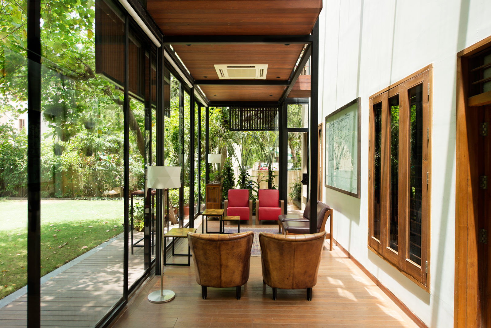 The ground-floor living area of the extension features tan leather chairs from Sidewalks of the World - Beautiful Homes