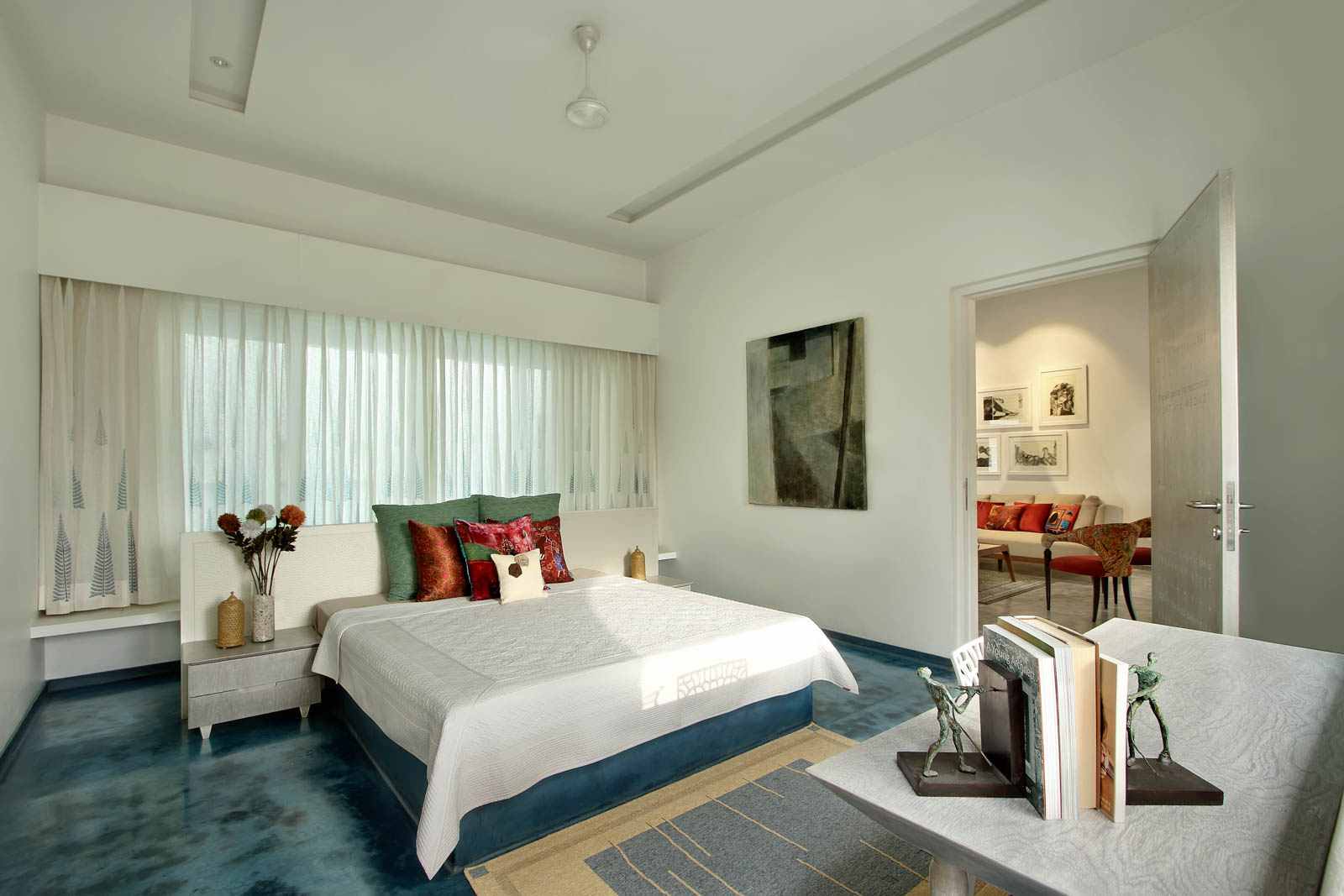 A bedroom in shades of white and blue at the Vadodara farmhouse  - Beautiful Homes
