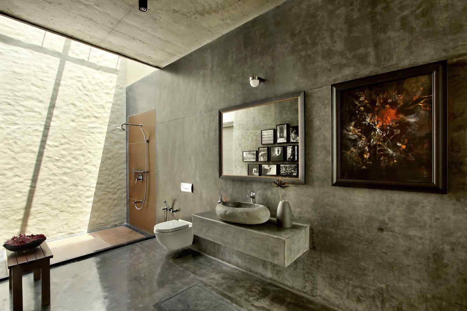 The all-grey cement finish gives the bathroom at the Vadodara farmhouse  - Beautiful Homes