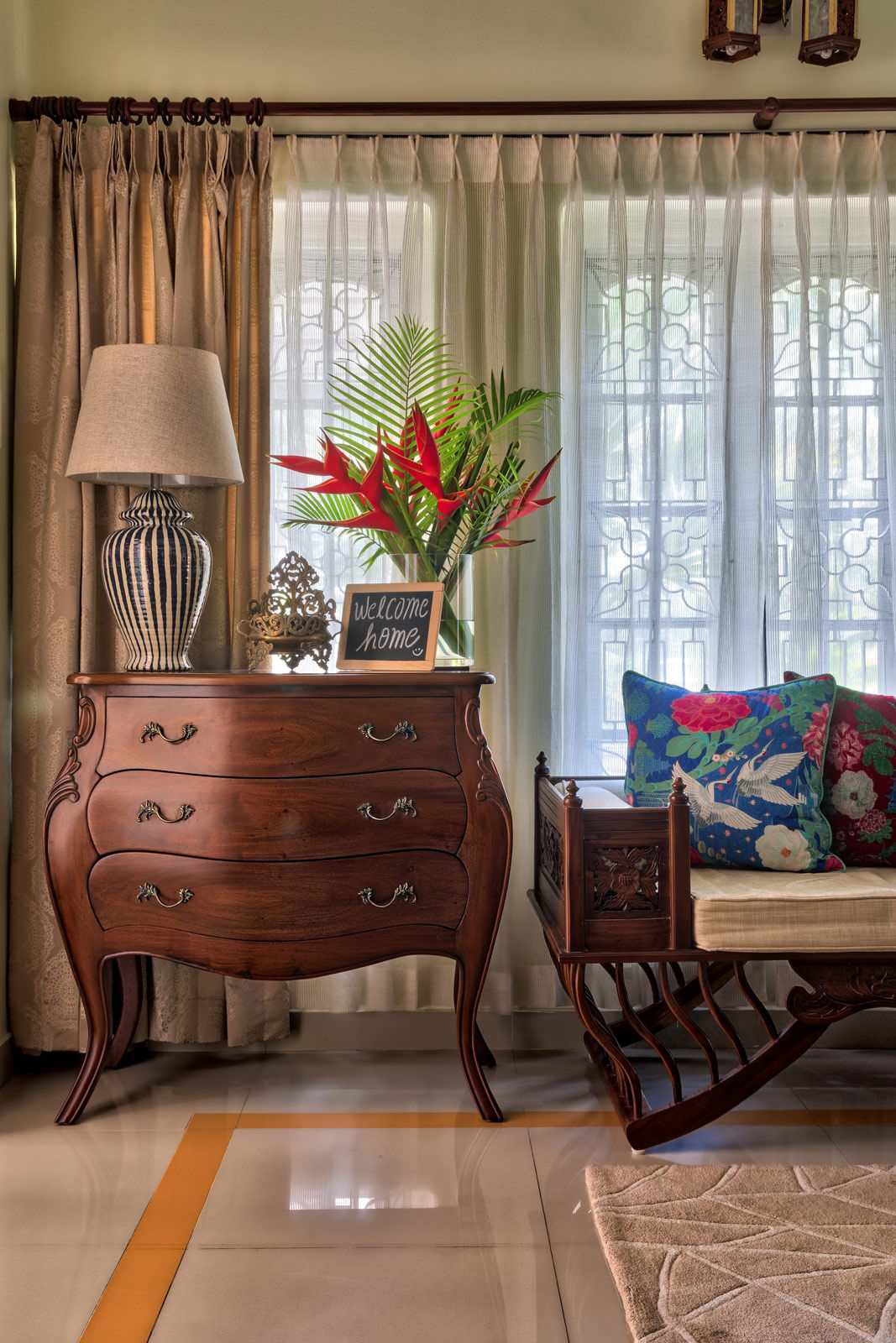 An antique chest of drawers with an elegant table lamp in the living room - Beautiful Homes