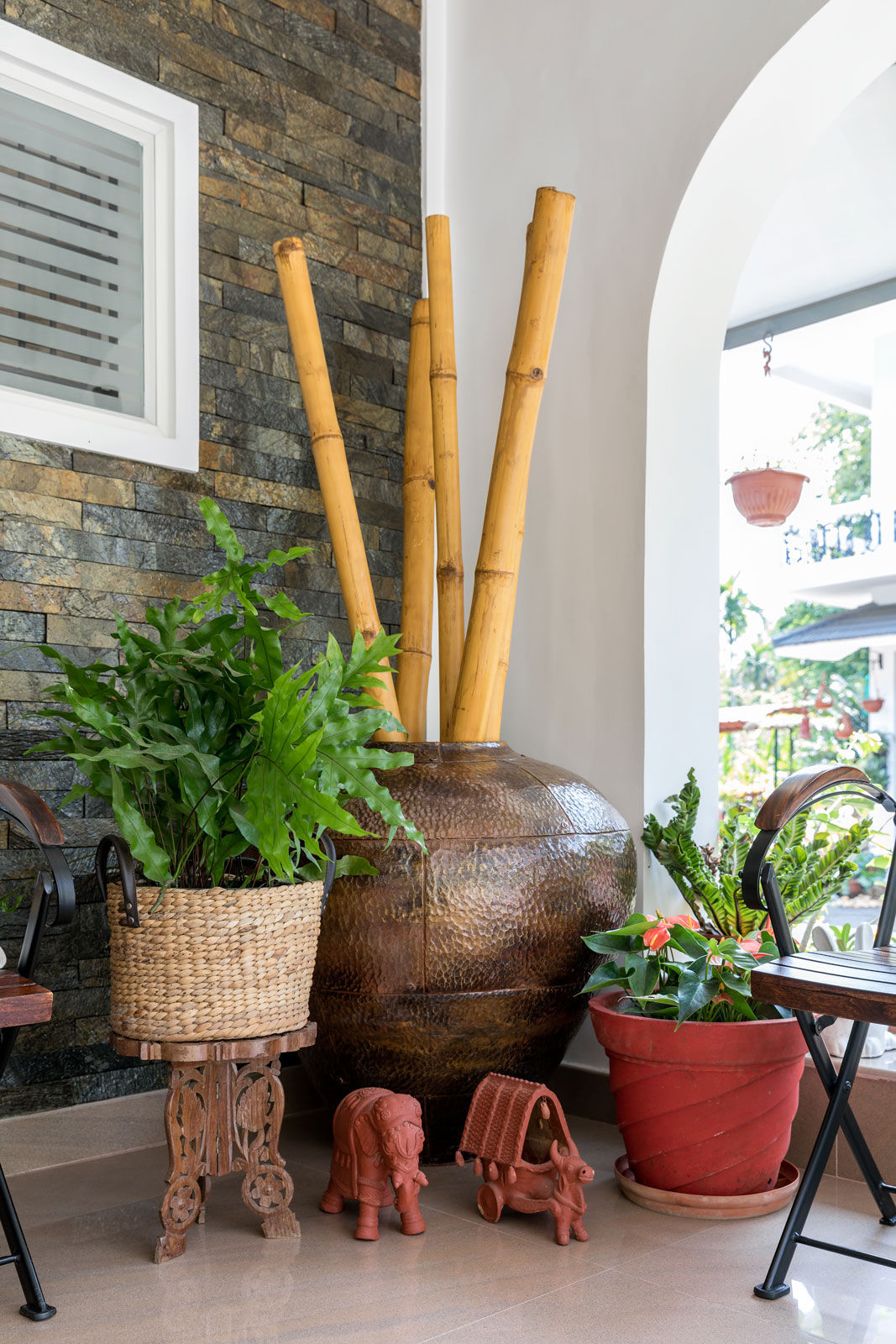 A corner with different materials and textures like beaten metal, woven jute and carved wood - Beautiful Homes