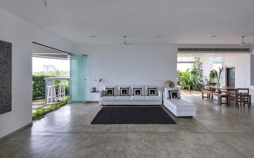 The spacious living room has sections for sitting area & dining area opening to a balcony - Beautiful Homes