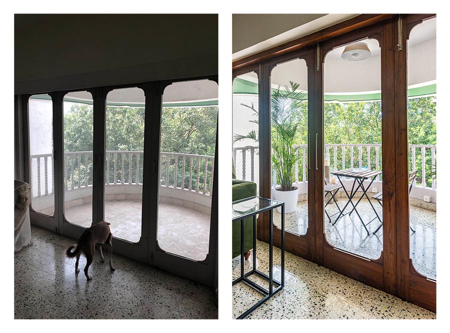 Large wooden glass doors leading to a balcony which has a small table and a couple of chairs - Beautiful Homes