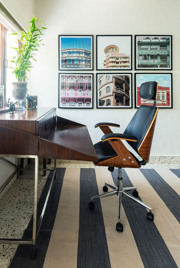 Office furniture in midcentury style, leather chair and wooden desk, architecture photographs on the wall - Beautiful Homes