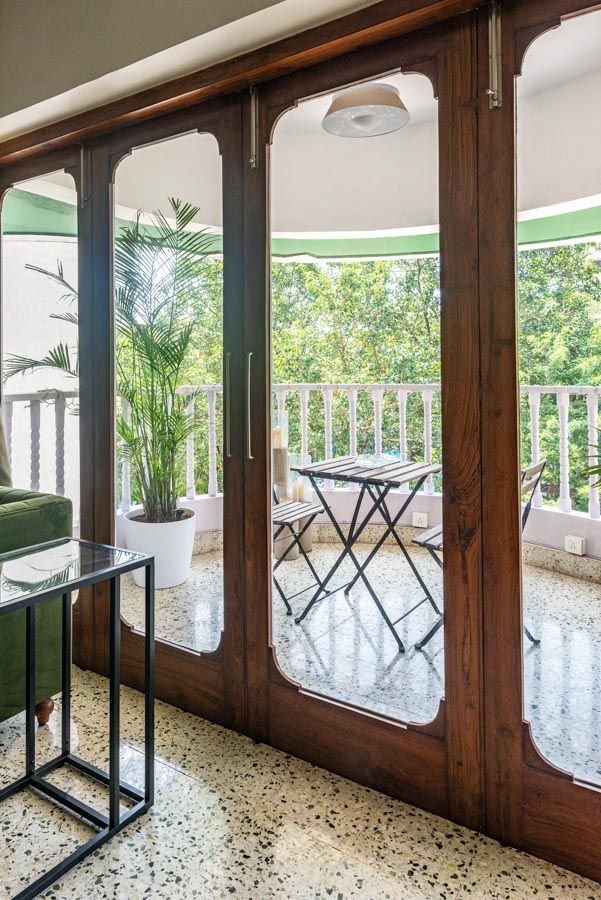 Large glass doors with a wooden frame next to a balcony - Beautiful Homes