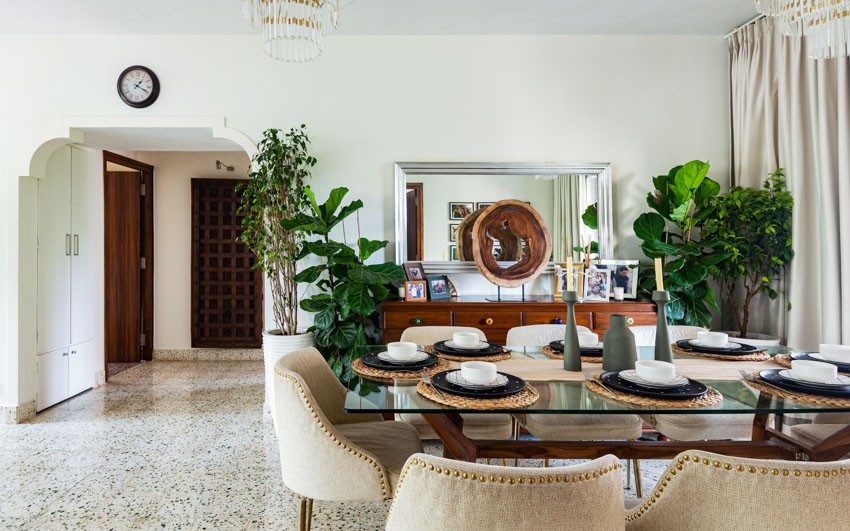 Bright living room with big dining table in glass and wood