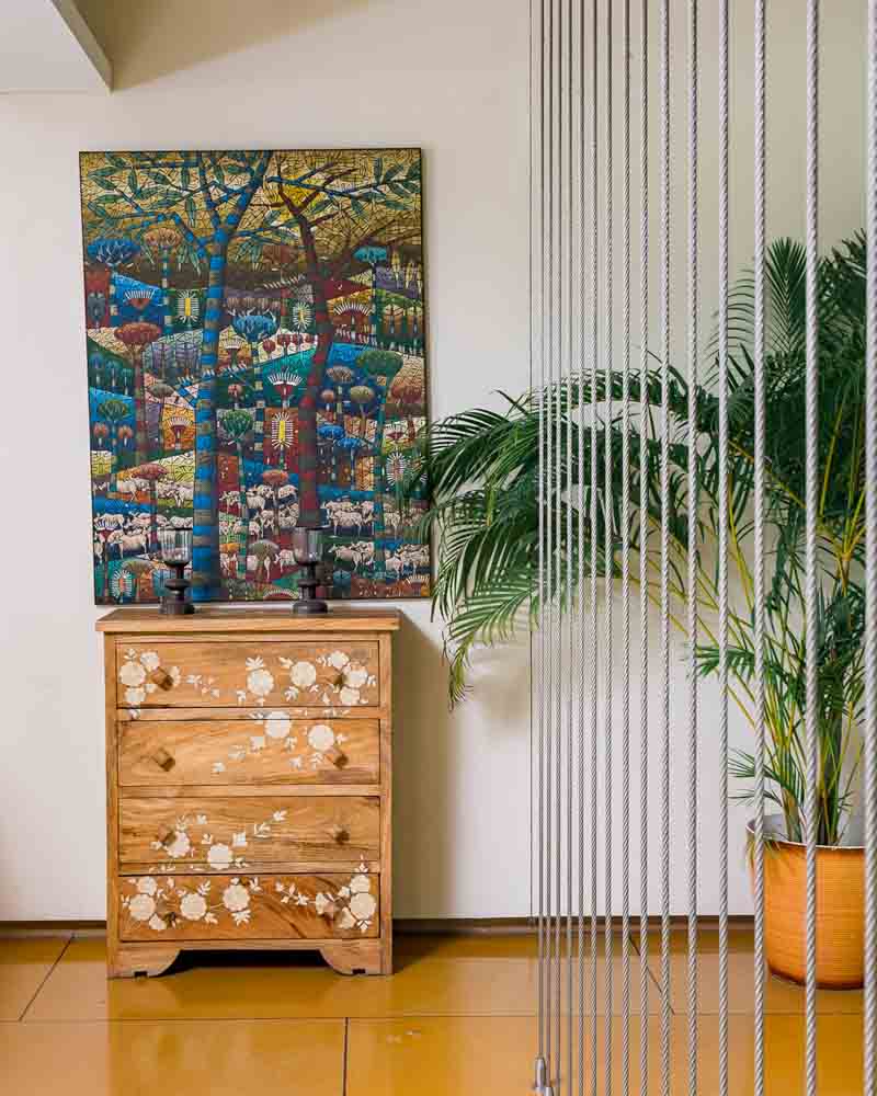 Beautiful pichwai painting enhancing the wall design paired with houseplant - Beautiful Homes