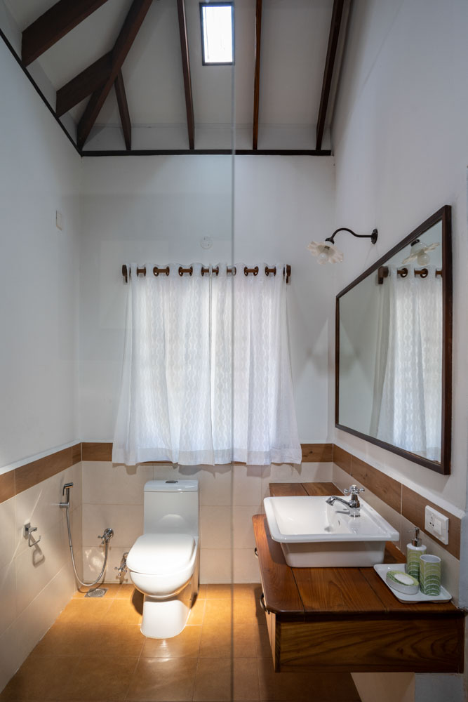 The bathroom has wooden vanity & ochre coloured flooring - Beautiful Homes