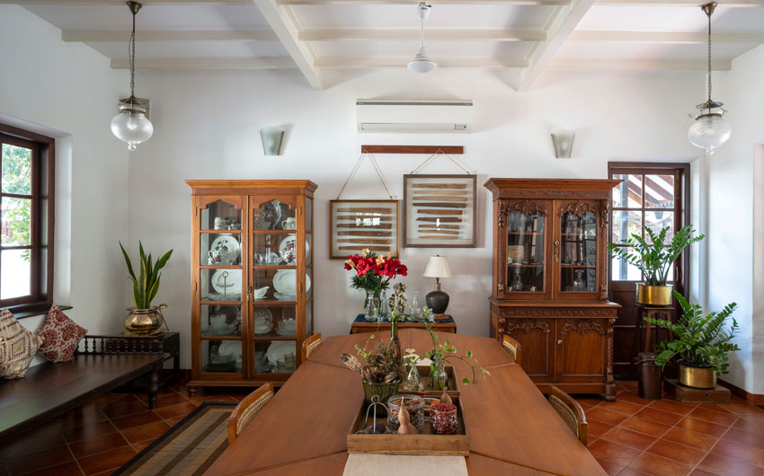 Dining room storage has wooden & glass cabinets for crockery collection - Beautiful Homes