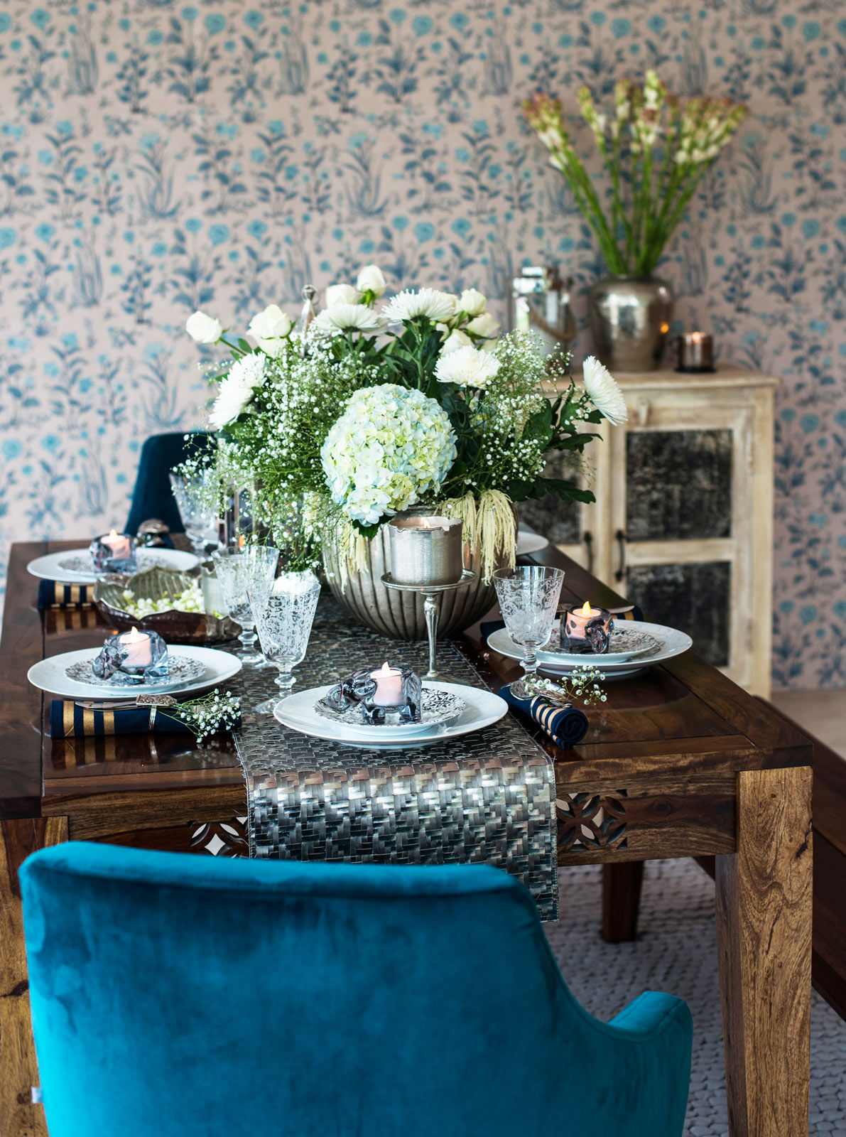 Dining room decorated with soft whites, shimmery silvers and a host of fresh flowers - Beautiful Homes