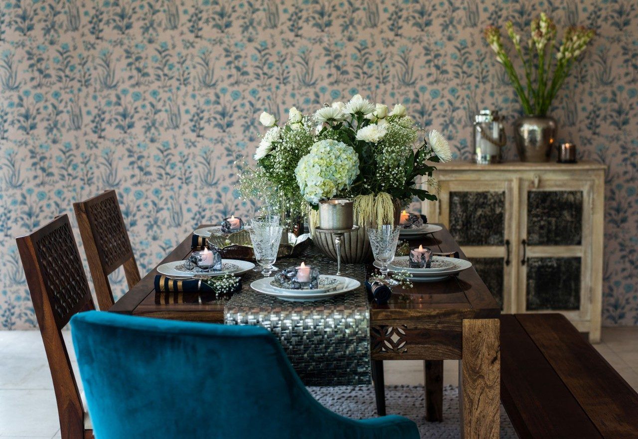 Dining room decorated with soft whites, shimmery silvers and a host of fresh flowers - Beautiful Homes