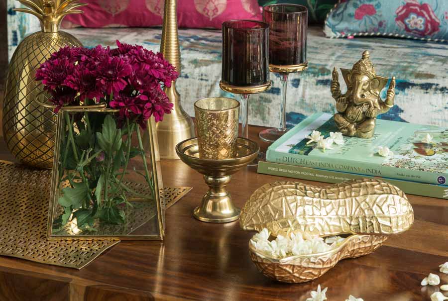 A table with flowers and gold accessories