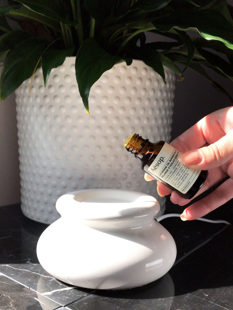 Essential oil being poured into a diffuser