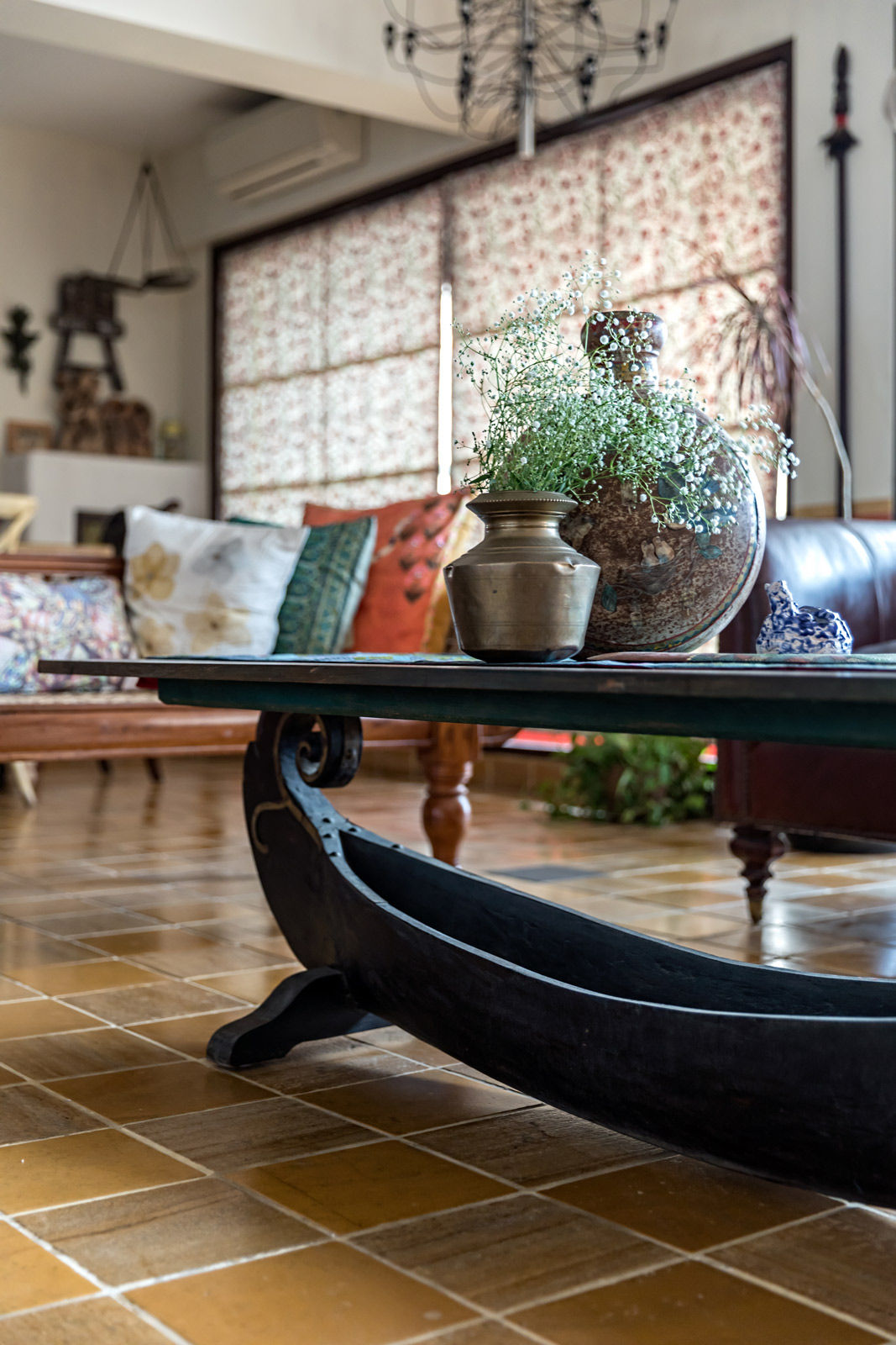 A center table decorated with flowers in brass pots - Beautiful Homes