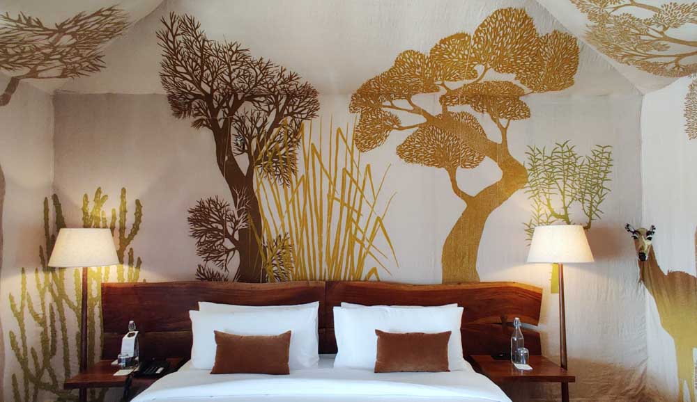 A bedroom with an artwork on fabric by textile artist Dhvani Behl
