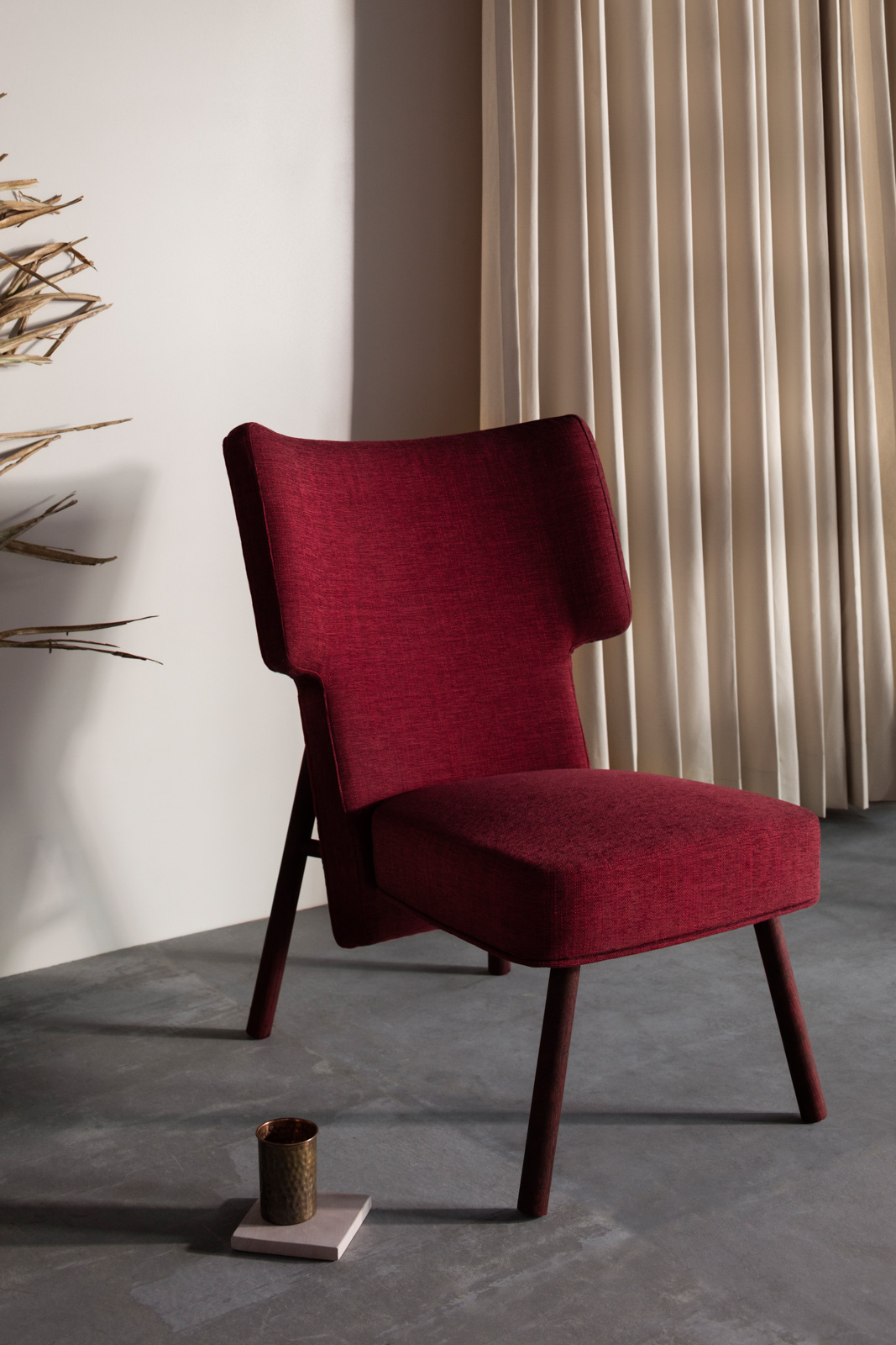 With a curved backrest, soft cushioning in a dual-tone combination of shiraz and scarlet, and red-stained wooden legs, the ‘Aza’ lounge chair by Quentin Voung from France is all about clean, modern design.