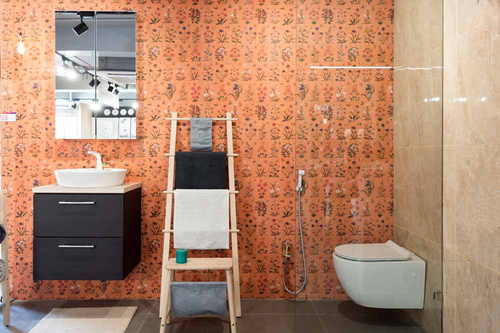 A bathroom with floral wallpaper