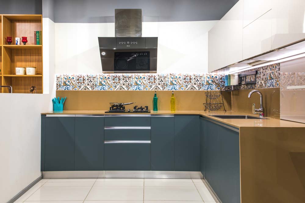 A kitchen with grey cabinets and a tiled backsplash