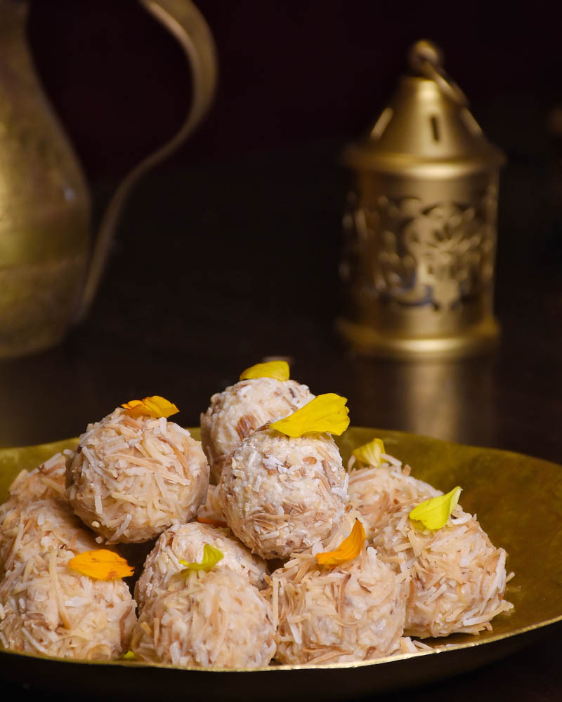 White chocolate coconut ladoos placed on a brass plate