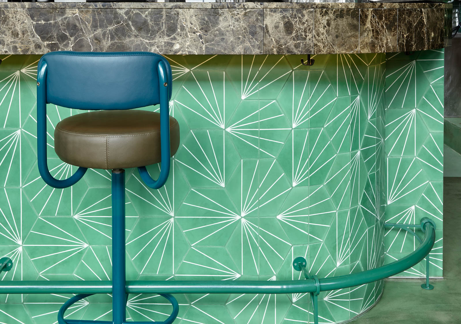 A Bar Front Decorated with Leaves at Jungle-inspired Bar - Beautiful Homes