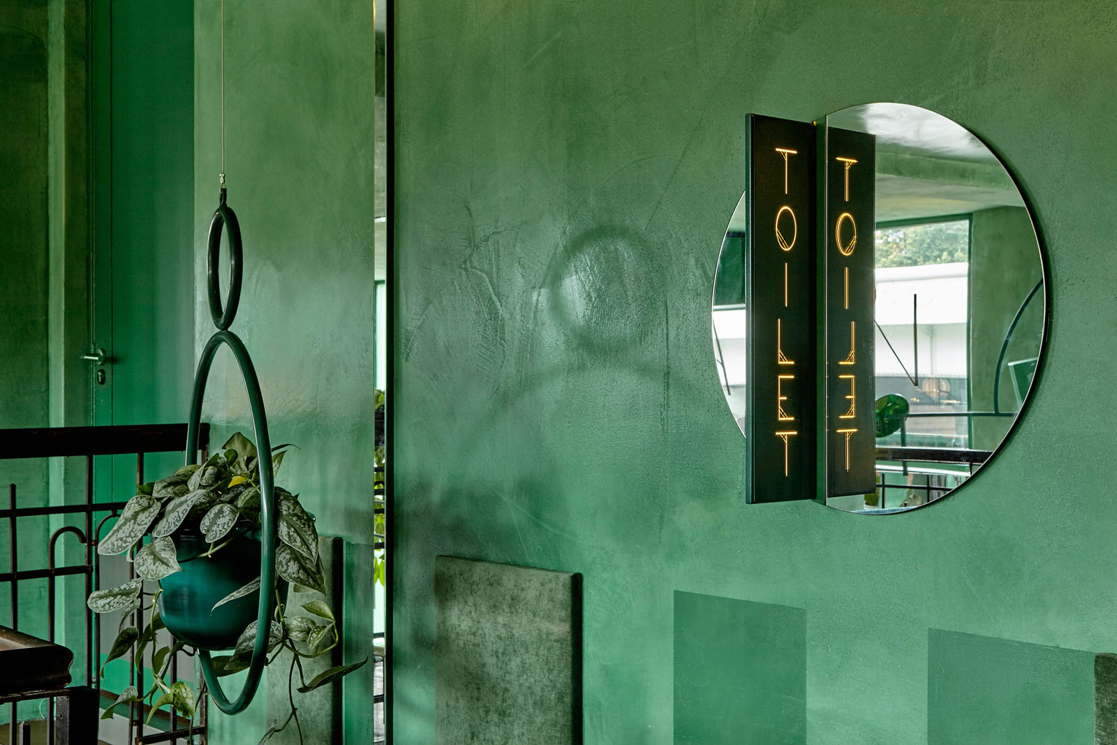 A Bar Decorated with Jade Green Walls at Jungle-inspired Bar - Beautiful Homes