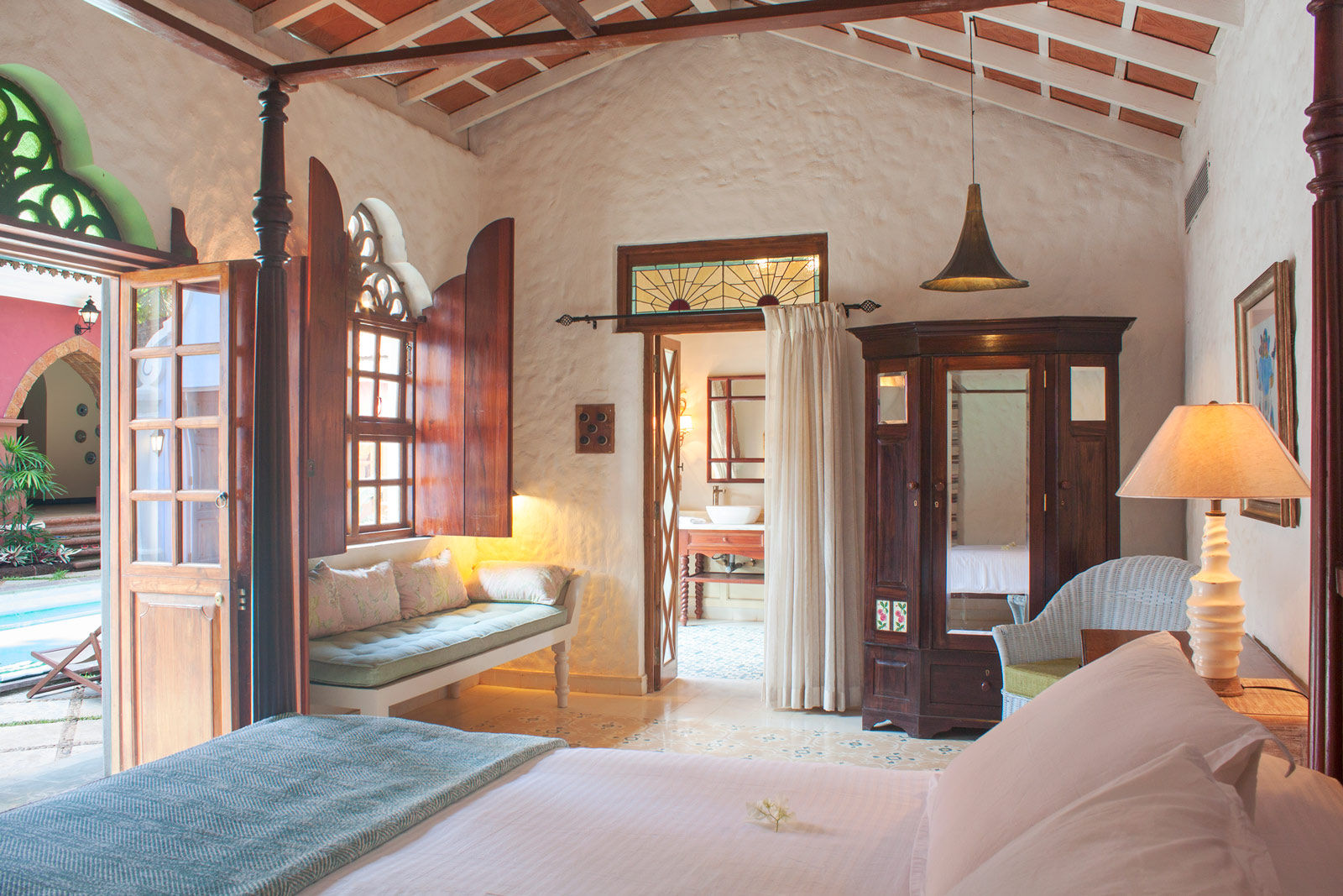 A bedroom designed withCarved arches, stained glass and metal lamps pair beautifully with a minimalist daybed - Beautiful Homes