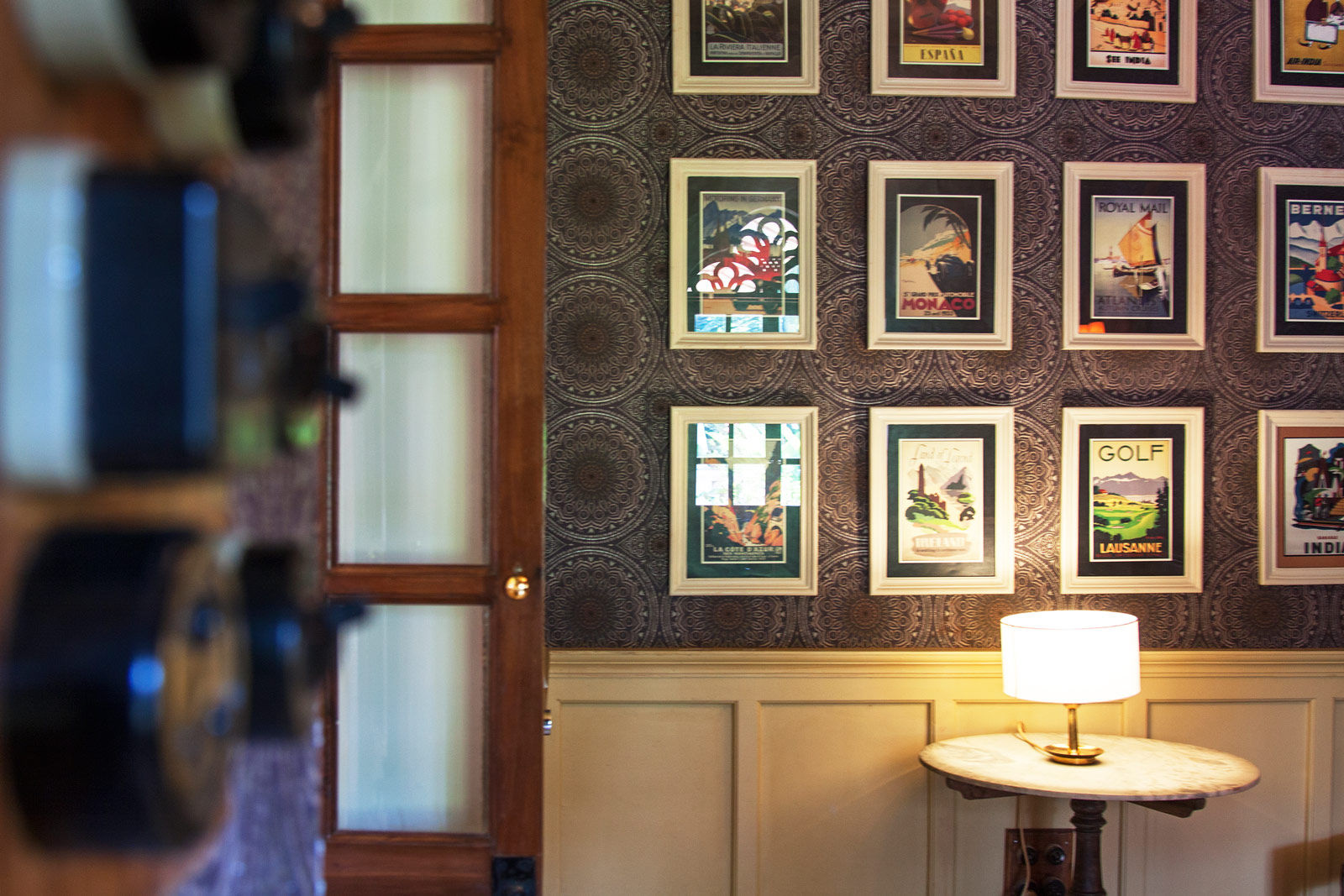 A featured wall with a twist – against a dark, geometrically patterned wallpaper - Beautiful Homes