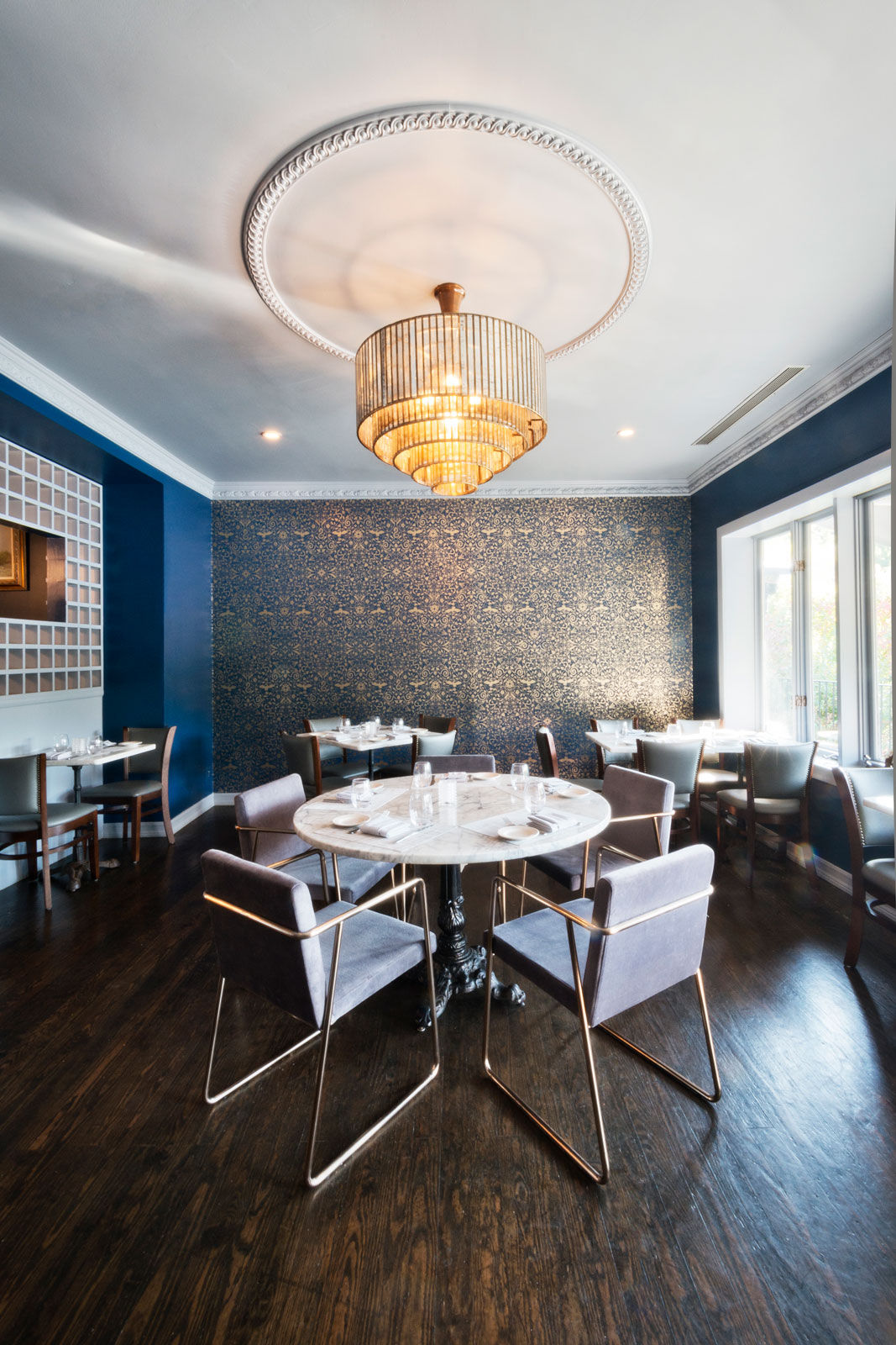The centrally placed, ornate chandelier hearkensThe centrally placed, ornate chandelier hearkens above the dining place - Beautiful Homes