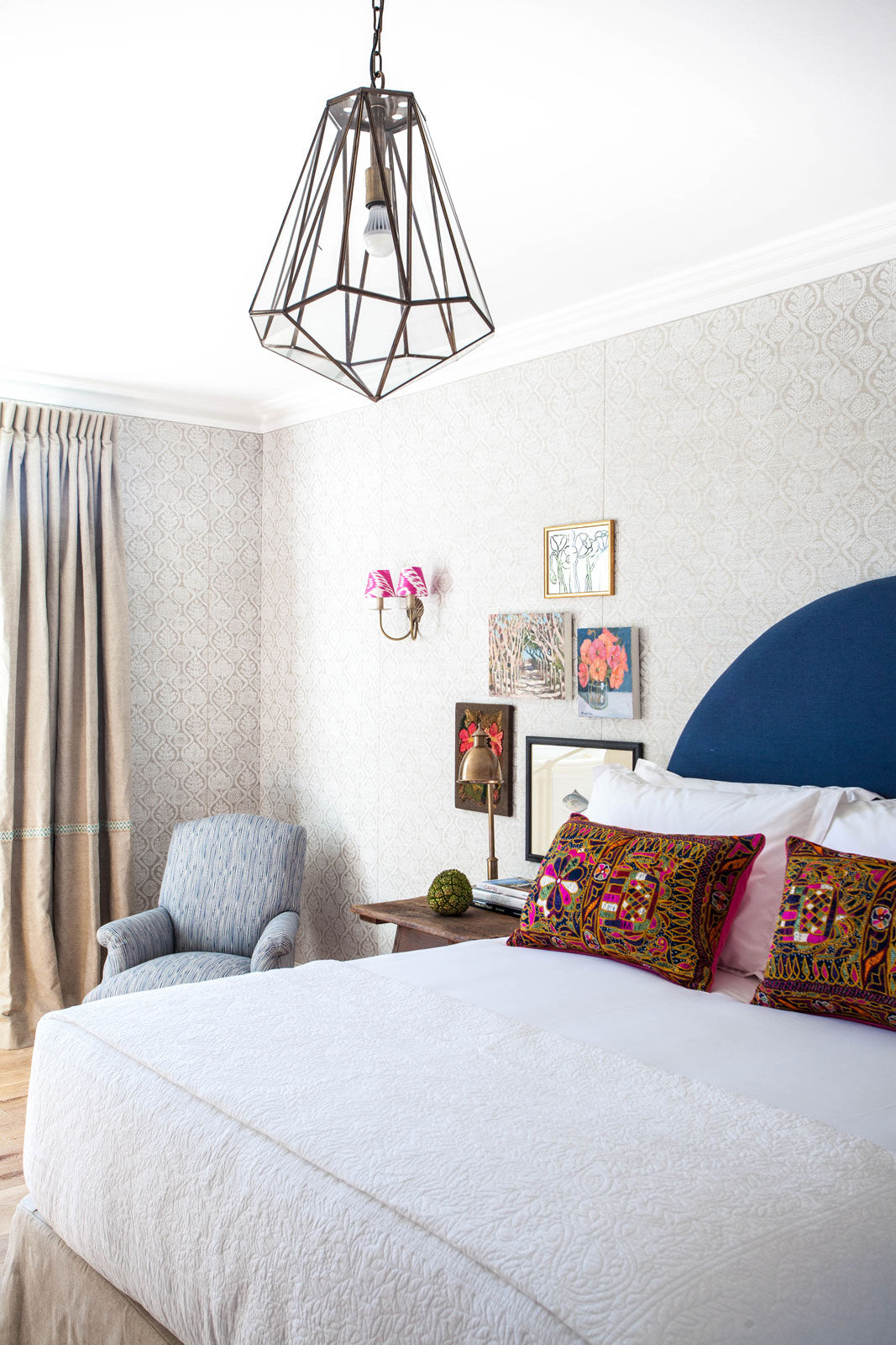 A patterned wallpaper paired with a loud headboard in a bedroom for dramatic effect - Beautiful Homes