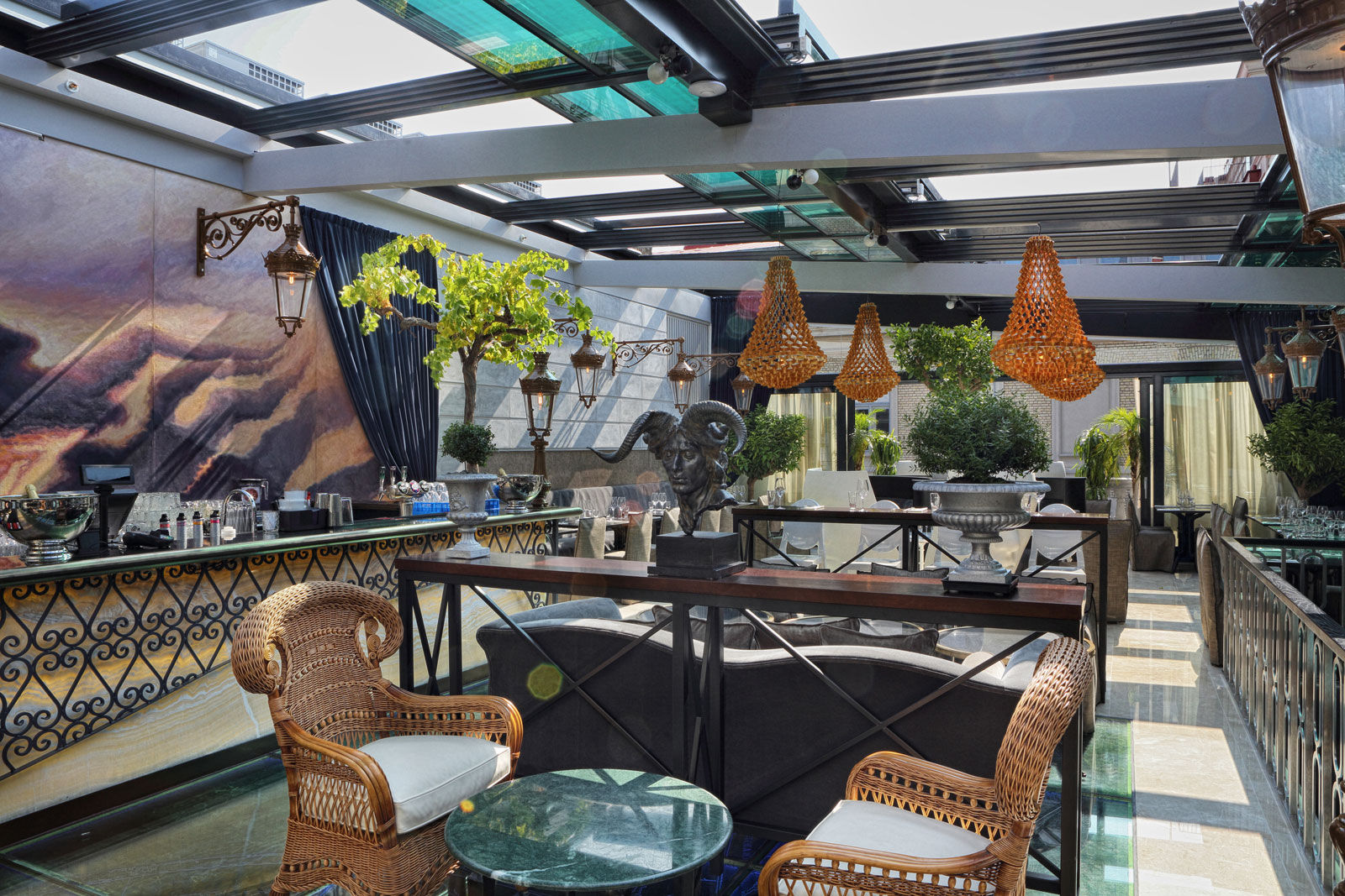 A Cafe Area Decorated with Knit-like, woven chairs and chandeliers at the Le Pain Français Cafe - Beautiful Homes