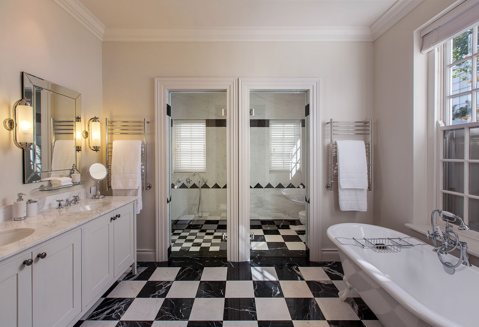 A sprawling bathroom with chequered floor tiles at Leeu House in Cape Town - Beautiful Homes