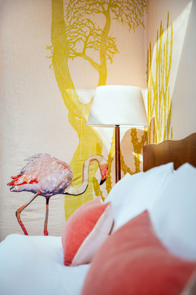 Tent Interior With Embroidery Design Of Of A Flamingo & A Tree Next To A Bed Along With A Standing Lamp - Beautiful Homes
