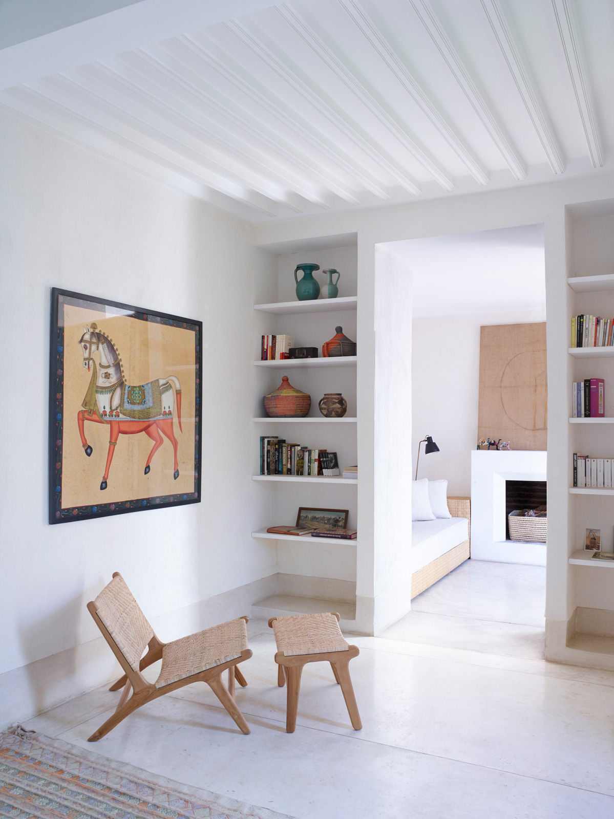 A built-in wall shelves eliminate the need for external bookshelves - Beautiful Homes