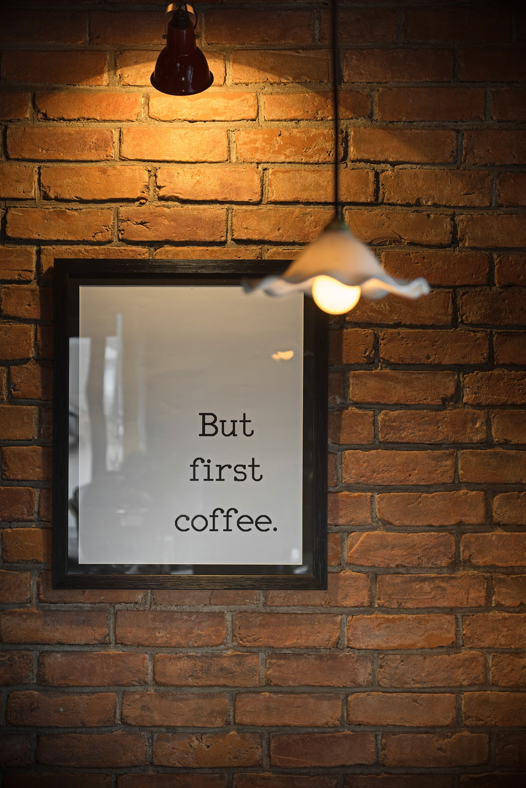 Exposed bricks making an interesting backdrop for framed quotes at the The Rice Mill Cafe - Beautiful Homes