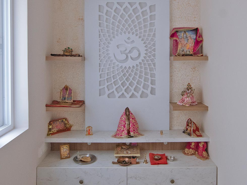 a pooja room with storage options
