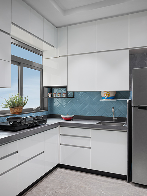 All white kitchen with blue glossy backsplash