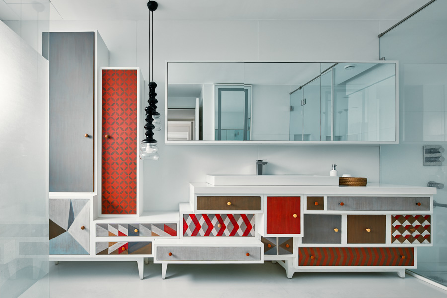 Bathroom ceiling lights in elongated curved shapes in a bathroom with many geometric patterns