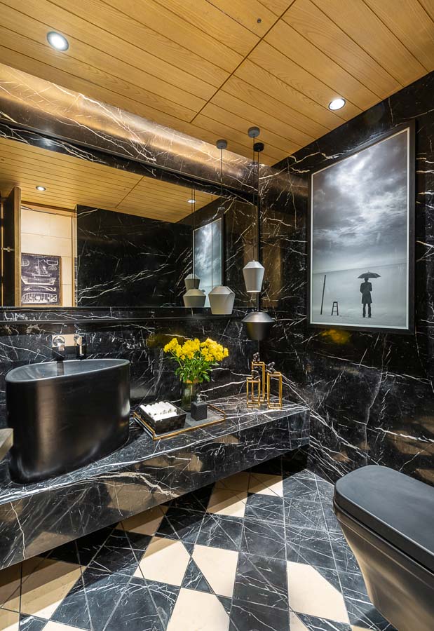 Concealed bathroom ceiling lights in wooden false ceilings, black and white marble on the floor and walls