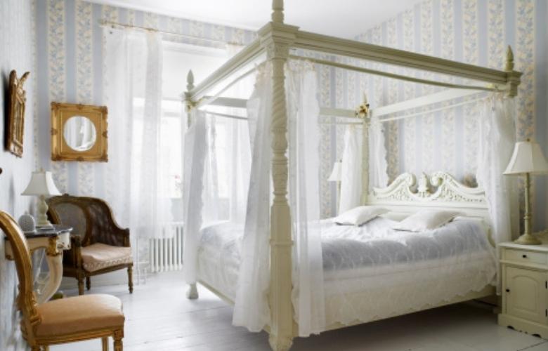 An all white bedroom with elegant victorian style four poster bed & sheer curtains - Beautiful Homes