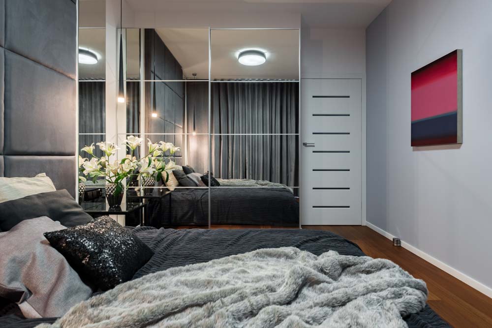 Wardrobe design with doors of mirror that look like a wall in your bedroom design - Beautiful Homes