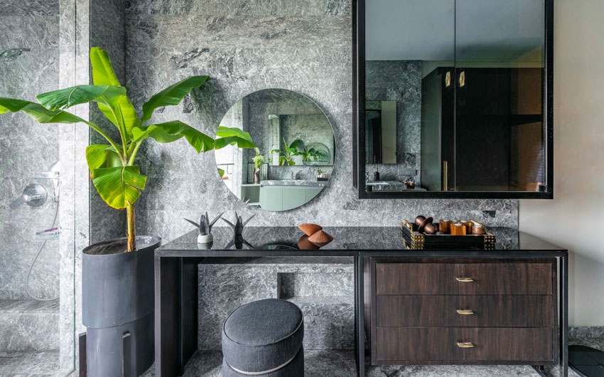 Dressing table with mirror in black modern bedroom design against granite wall with banana plant - Beautiful Homes