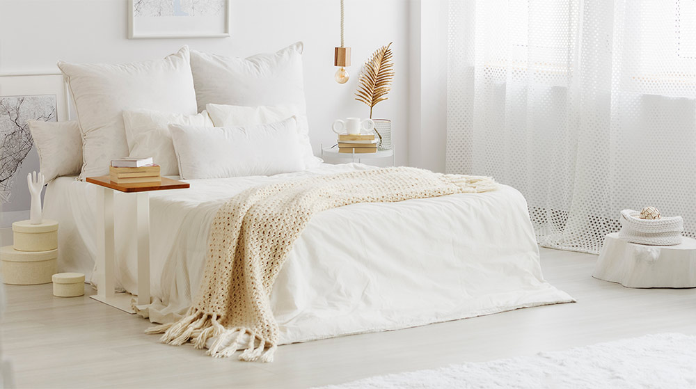 All-white bedroom with brick panelling - Beautiful Homes