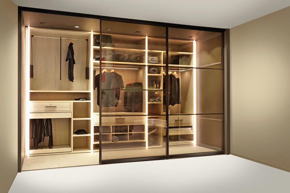 Give a chic look to your wardrobe design by putting up glass sliding door as partitions - Beautiful Homes