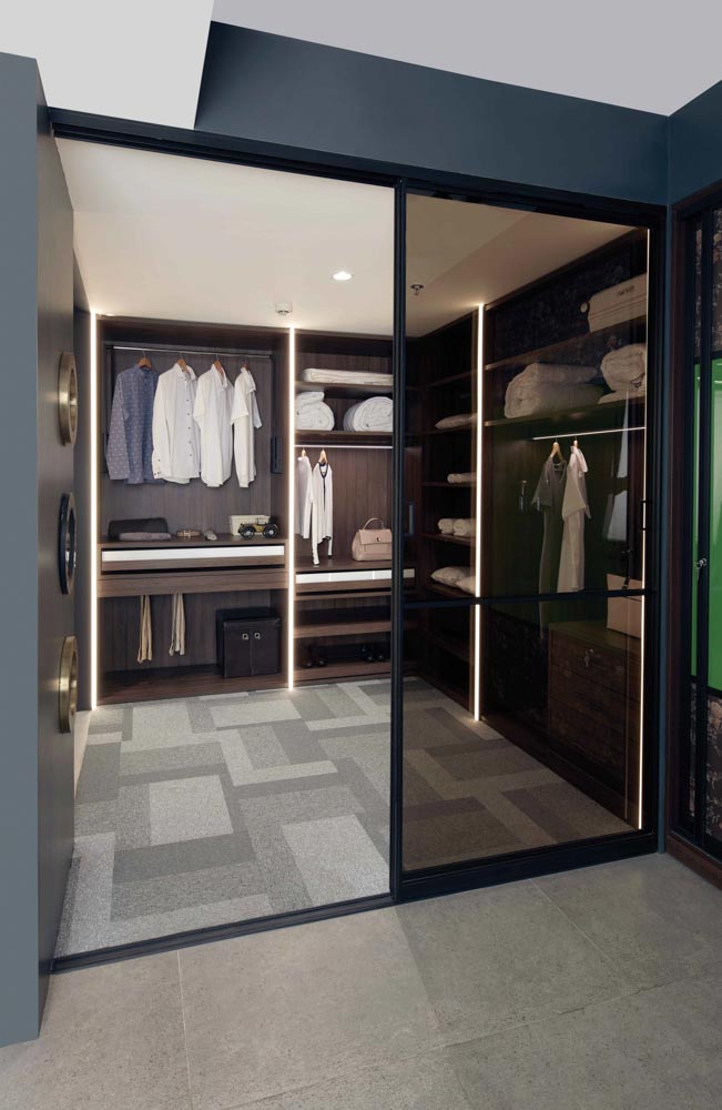 Walk-in wardrobe design in vertical manner partitioned with glass sliding door - Beautiful Homes