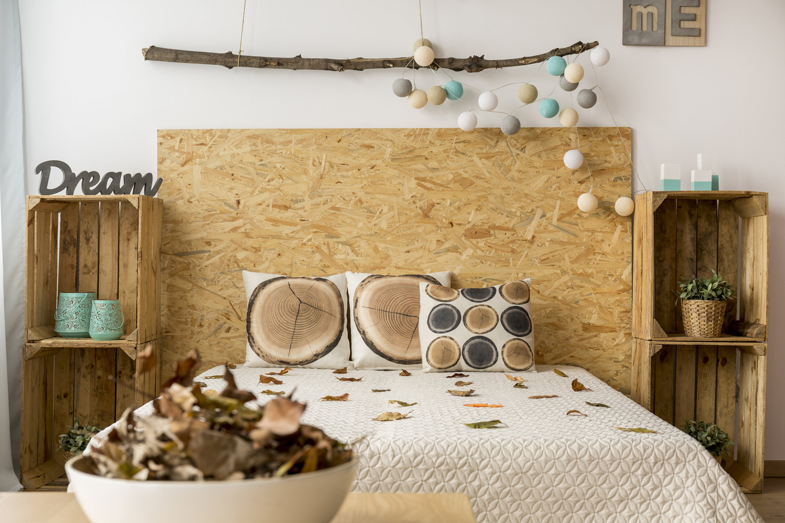 Wooden crates work well as bedside tables to induce some warmth - Beautiful Homes
