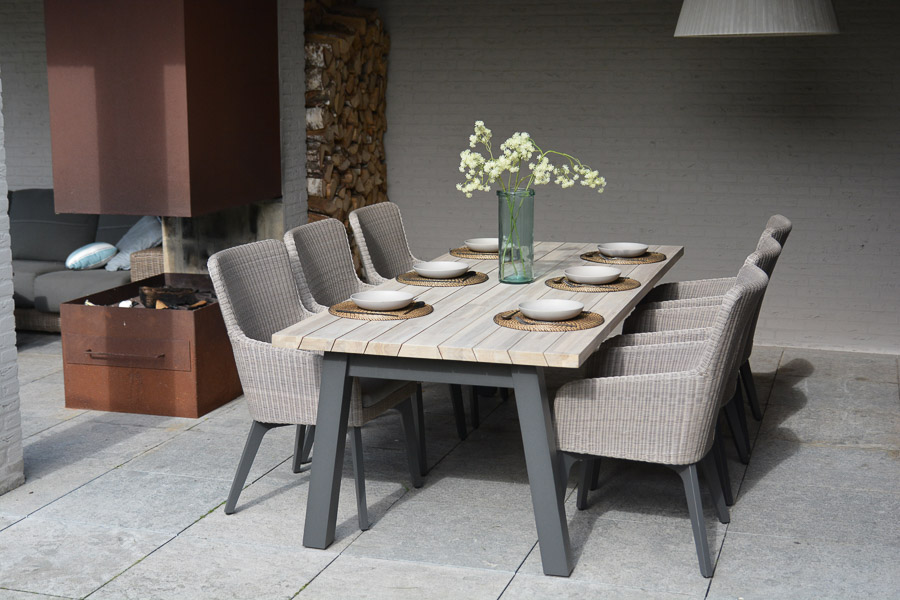 Teak wood dining table on stone floor - Beautiful Homes