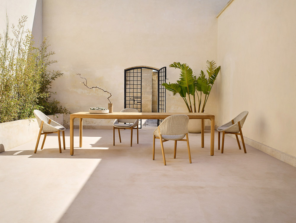 Teak wood dining table set in a minimal outdoor area - Beautiful Homes